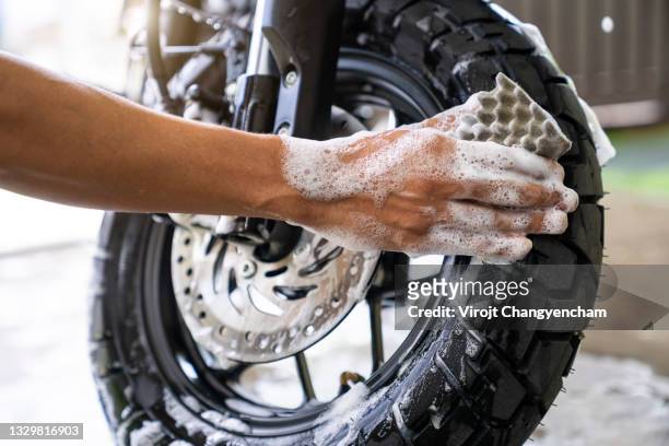 hand wash motorcycle tire at home - motorbike wash stock pictures, royalty-free photos & images