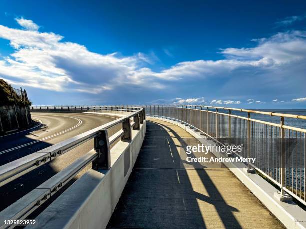 walking over the sea cliff bridge coastal highway - crash barrier stock pictures, royalty-free photos & images
