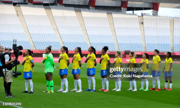 Players of Team Brazil stand for the national anthem prior to the Women's First Round Group F match between China and Brazil during the Tokyo 2020...