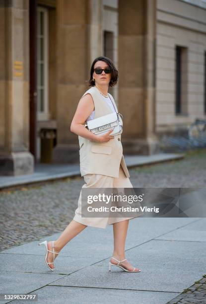 Sophie van Daniels is seen wearing creme white vest ARKET, top Arket, Culottes Uterque, bag Proenza Schouler, shoes Zara on July 20, 2021 in Berlin,...