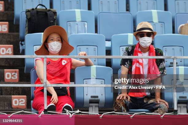 Fans of Team China wear face masks inside the stadium prior to the Women's First Round Group F match between China and Brazil during the Tokyo 2020...