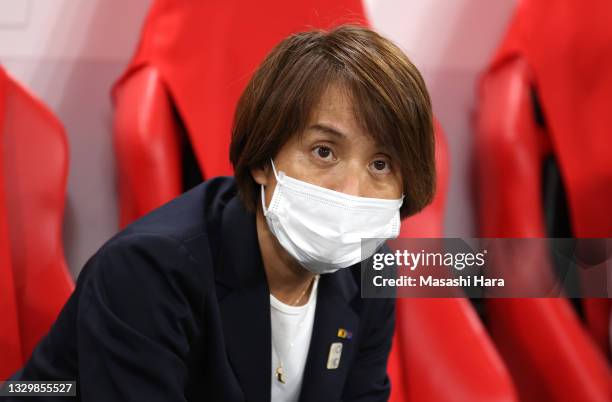 Asako Takakura, Head Coach of Team Japan wears a face mask prior to the Women's First Round Group E match between Japan and Canada during the Tokyo...