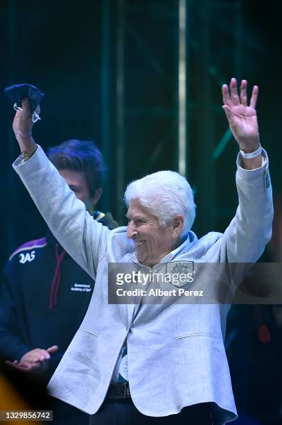 Champion Australian Olympic swimmer Dawn Fraser waves to the crowd during the announcement of the host city for the 2032 Olympic Games, watched via...