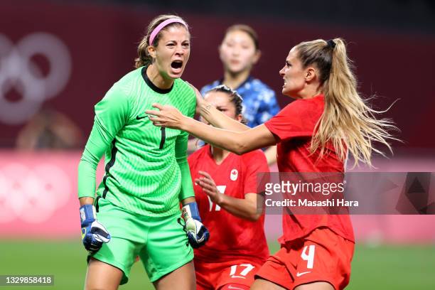 Stephanie Labbe of Team Canada celebrates and is congratulated by teammate Shelina Zadorsky after saving a penalty taken by Mina Tanaka Team Japan...