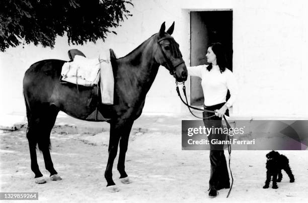 Italian actress Lucia Bose with her horse on her farm of Villa Paz, Saelices, Cuenca, Spain, 1967.