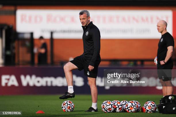 Kevin O'Connor, Assistant First Team Coach of Brentford looks on as players warm up prior to the Pre-Season Friendly match between Boreham Wood and...