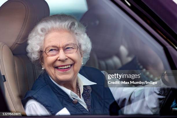 Queen Elizabeth II seen driving her Range Rover car as she attends day 2 of the Royal Windsor Horse Show in Home Park, Windsor Castle on July 2, 2021...