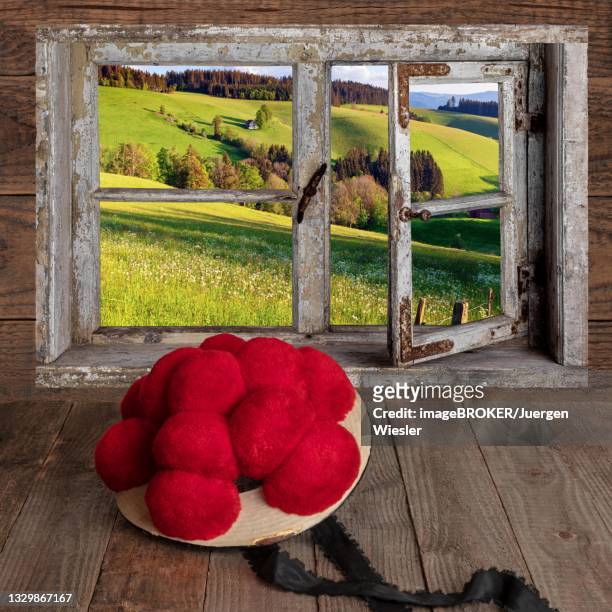 view through a window with bollen hat on wooden table, composing, germany - bollenhut stock pictures, royalty-free photos & images