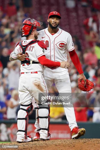 Tucker Barnhart and Amir Garrett of the Cincinnati Reds celebrate after beating the New York Mets 4-3 at Great American Ball Park on July 20, 2021 in...