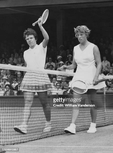 Billie Jean Moffitt of the United States holds her tennis racquet aloft to acknowledge the crowd after losing to Ann Haydon of Great Britain in their...