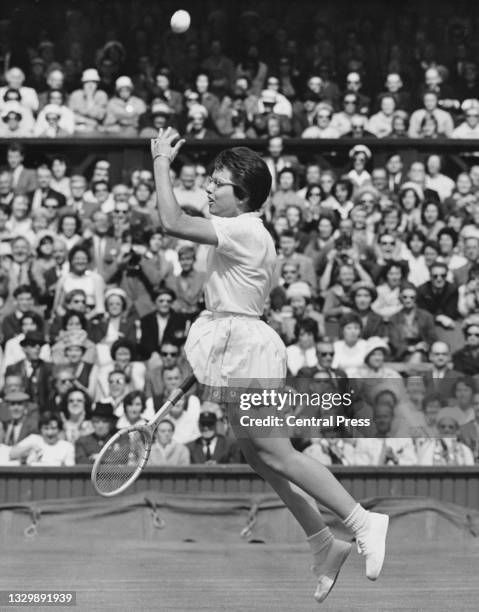 Billie Jean Moffitt of the United States throws the tennis ball away as she jumps into the air in celebration after defeating Margaret Court of...