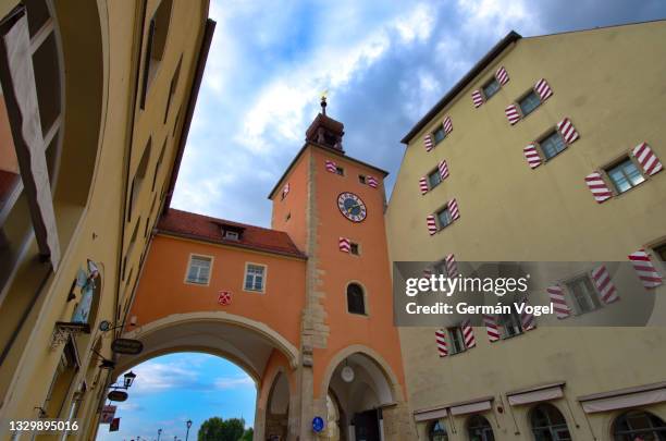 regensburg landmark medieval bridge gate clock tower, bavaria, germany - regensburg stock-fotos und bilder