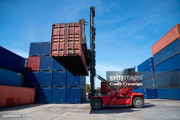 industrial logistic forklift truck containers had lifted the container box and hold in the container yard. - construction crane asia stockfoto's en -beelden