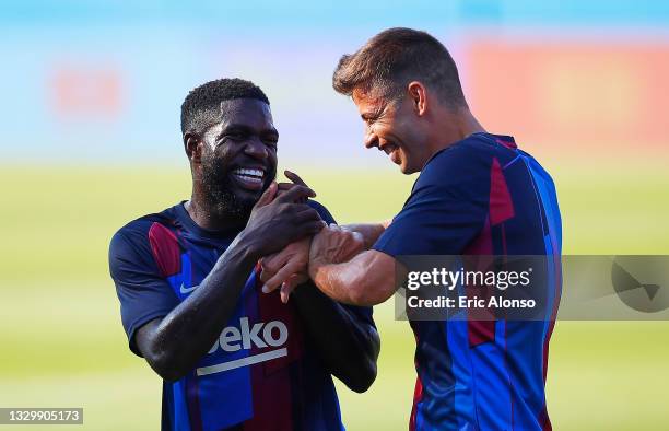 Samuel Umtiti and Gerard Piqué of FC Barcelona react during a friendly match between FC Barcelona and Gimnastic de Tarragona at Johan Cruyff Stadium...