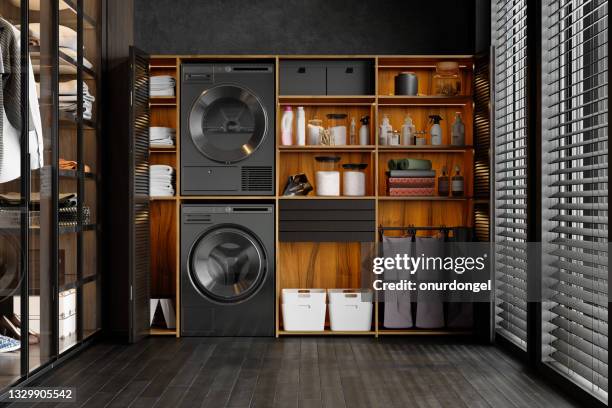 luxuriöse waschküche mit waschmaschine, trockner, wäschekorb und gefalteten handtüchern im schrank - waschmaschine raum stock-fotos und bilder