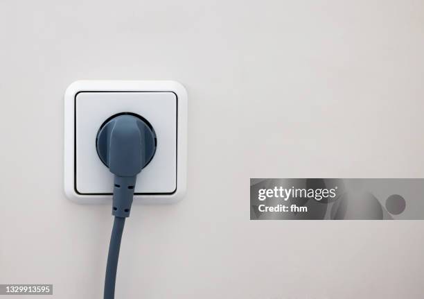 plug and socket - enchufes fotografías e imágenes de stock