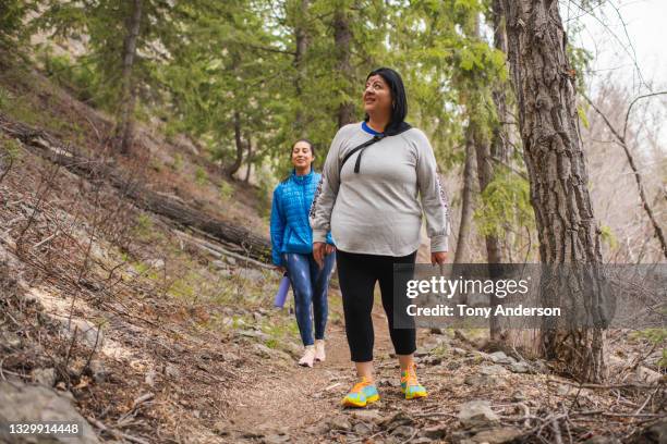 mother and adult daughter hiking on mountain trail - leggings fashion stock pictures, royalty-free photos & images