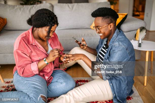 nail polishing with friend at home - painting fingernails stock pictures, royalty-free photos & images