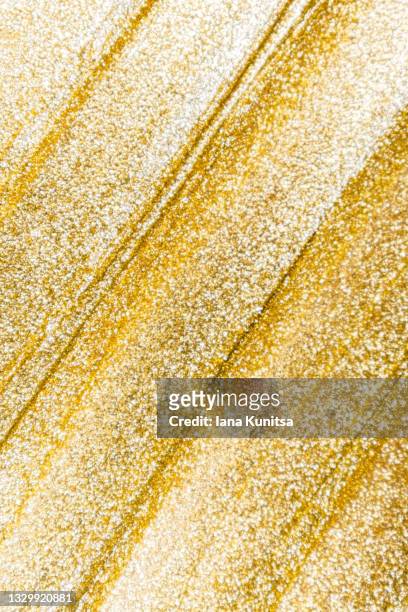 golden smudged texture of paint, nail polish. cosmetic products. makeup. copy space. vertical beauty banner. - beautiful metal stock-fotos und bilder