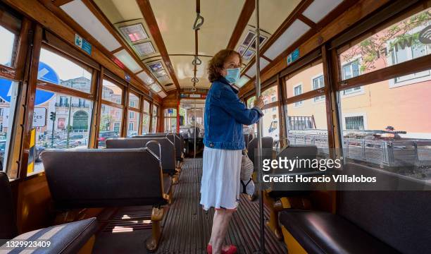 Mask-clad passenger waits to exit a 24 Line tram Rato during the COVID-19 Coronavirus pandemic on July 21, 2021 in Lisbon, Portugal. Portugal has...