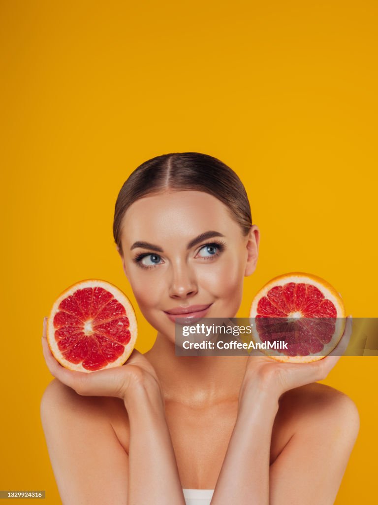 Beautiful girl with grapefruit