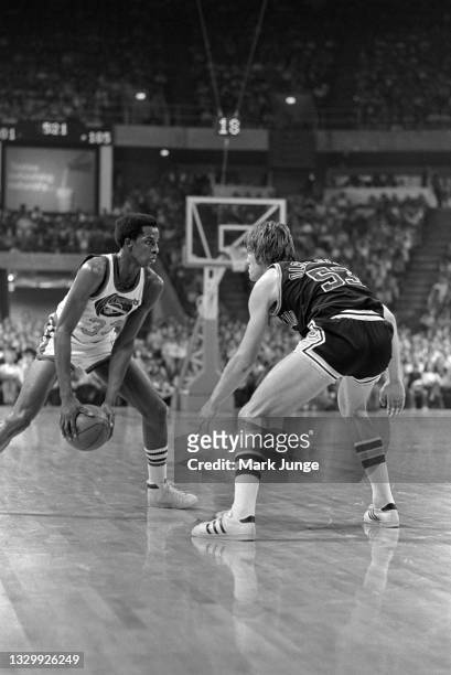 San Antonio Spurs forward Mark Olberding takes a defensive stance in front of Denver Nuggets forward David Thompson during an NBA basketball game at...