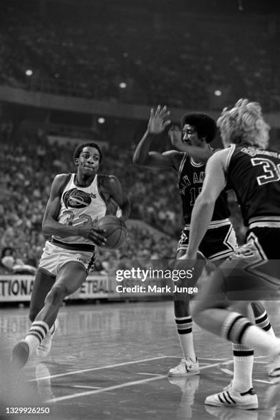 Denver Nuggets forward David Thompson drives past San Antonio Spurs guard Mike Gale in the lane during an NBA basketball game at McNichols Arena on...