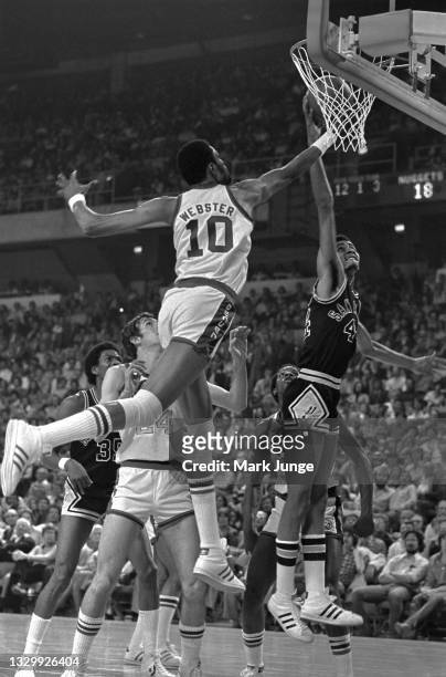 Denver Nuggets center Marvin Webster reaches out to block a layup by San Antonio Spurs forward George Gervin during an NBA basketball game at...