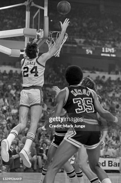 Denver Nuggets forward Bobby Jones jumps from behind the backboard toward the basket during an NBA basketball game against the San Antonio Spurs at...