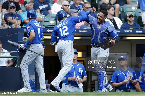 Salvador Perez of the Kansas City Royals congratulates Jorge Soler after hitting a solo home run in the eighth inning against the Milwaukee Brewers...