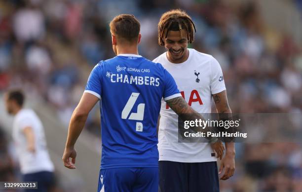 Dele Alli of Tottenham Hotspur interacts with Luke Chambers of Colchester United during the Pre-Season Friendly match between Colchester United and...