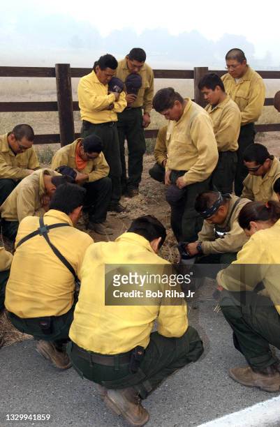 Navajo Hotshots from Window Rock, Arizona join in group prayer prior to starting a backfire in remote area during the Cedar Fire, near the town of...