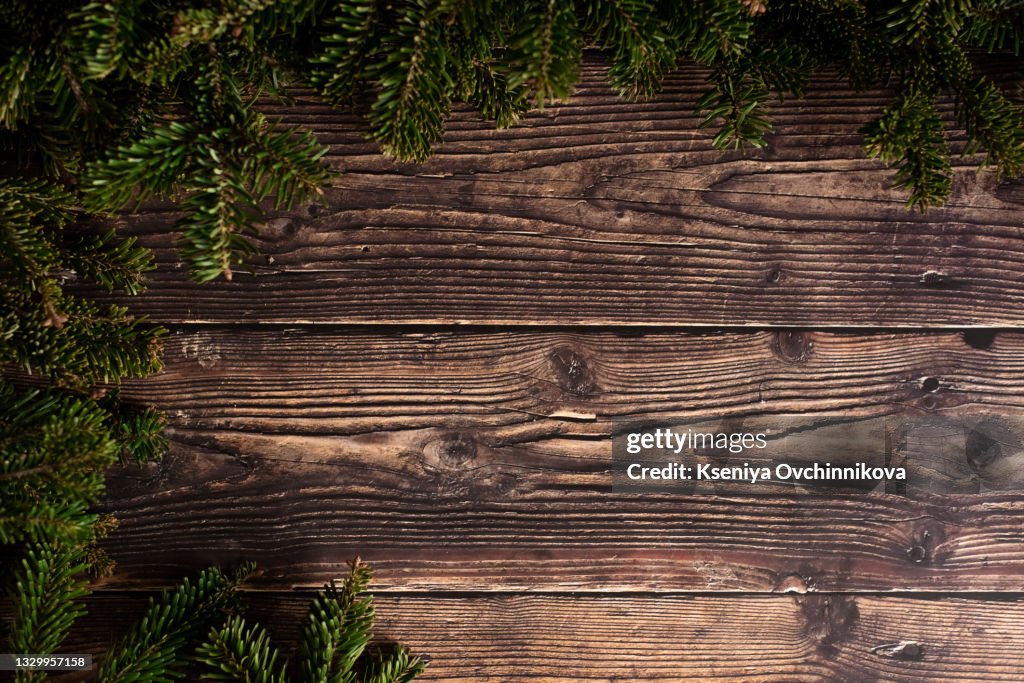 Christmas fir tree with decoration on dark wooden board