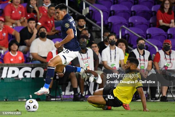 Adrian Mariappa of Jamaica and Adrian Martinez of Costa Rica fight for the ball during the first half at Exploria Stadium on July 20, 2021 in...