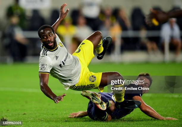 Kevin Molino of Columbus Crew falls as he takes a shot on goal in the second half during their game against Nashville SC at Lower.com Field on July...