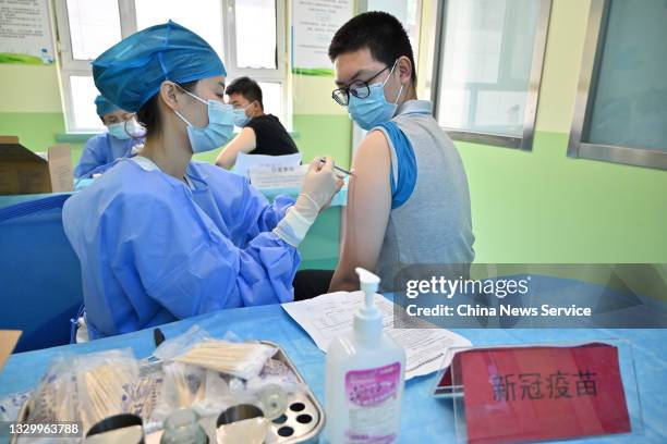 High school student receives a dose of COVID-19 vaccine at a vaccination site on July 21, 2021 in Hohhot, Inner Mongolia Autonomous Region of China.