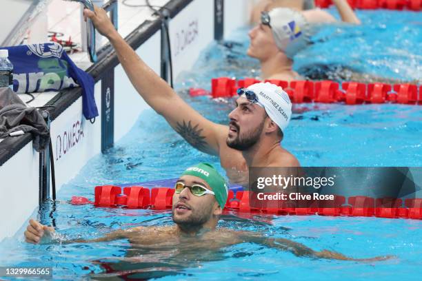 Enzo Martinez-Scarpe of Uruguay and Team Chad le Clos of Team South Africa look on during aquatics training at the Tokyo Aquatics Centre ahead of the...