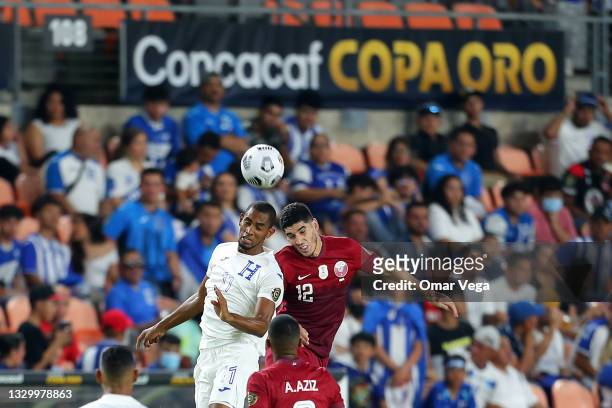 Jerry Bengtson of Honduras and Karim Boudiaf of Qatar fight for a header ball during a group D match between Honduras and Qatar as part of 2021...