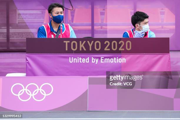 Workers watch as athletes of Team Japan practice in 3x3 basketball at Aomi Urban Sports Park ahead of the Tokyo 2020 Olympic Games on July 22, 2021...