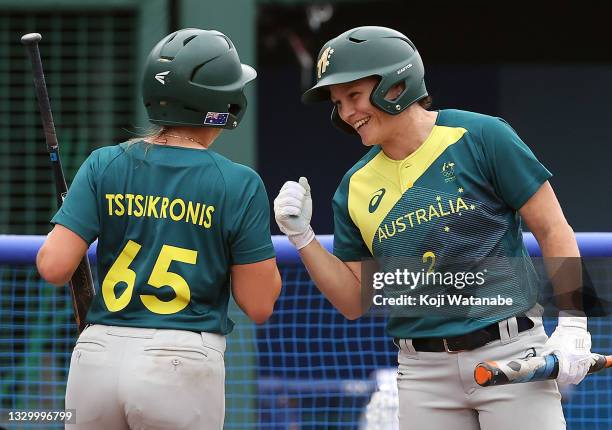 Taylah Tsitsikronis of Team Australia is congratulated by teammate Clare Warwick after Tsitsikronis scored in the second inning against Team Italy...