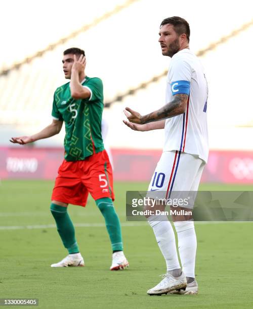 Andre-Pierre Gignac of Team France reacts after fouling Johan Vasquez of Team Mexico during the Men's First Round Group A match between Mexico and...