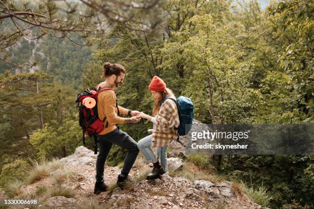 happy couple of hikers enjoying on a rocky mountain. - proposal stock pictures, royalty-free photos & images