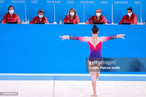 Judges wearing masks due to the Covid-19 pandemic look on as an athlete trains in the floor exercise during Women's Podium Training ahead of the...