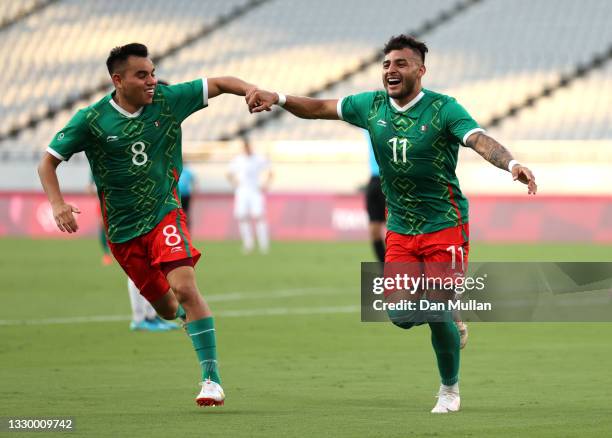 Alexis Vega of Team Mexico celebrates with teammate Carlos Rodriguez after scoring their side's first goal during the Men's First Round Group A match...