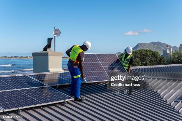 installing solar panels on a residential building - solar panel installation stock pictures, royalty-free photos & images