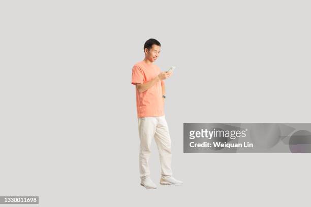 studio shot portrait of asian man - asian and indian ethnicities smartwatch phone stock pictures, royalty-free photos & images