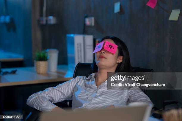 young female work hard and sleep while working late - stress arbeitsplatz stock-fotos und bilder