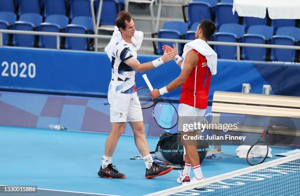 Andy Murray of Team Great shakes hands with Novak Djokovic of Team Serbia after a practice match ahead of the Tokyo 2020 Olympic Games at Ariake...