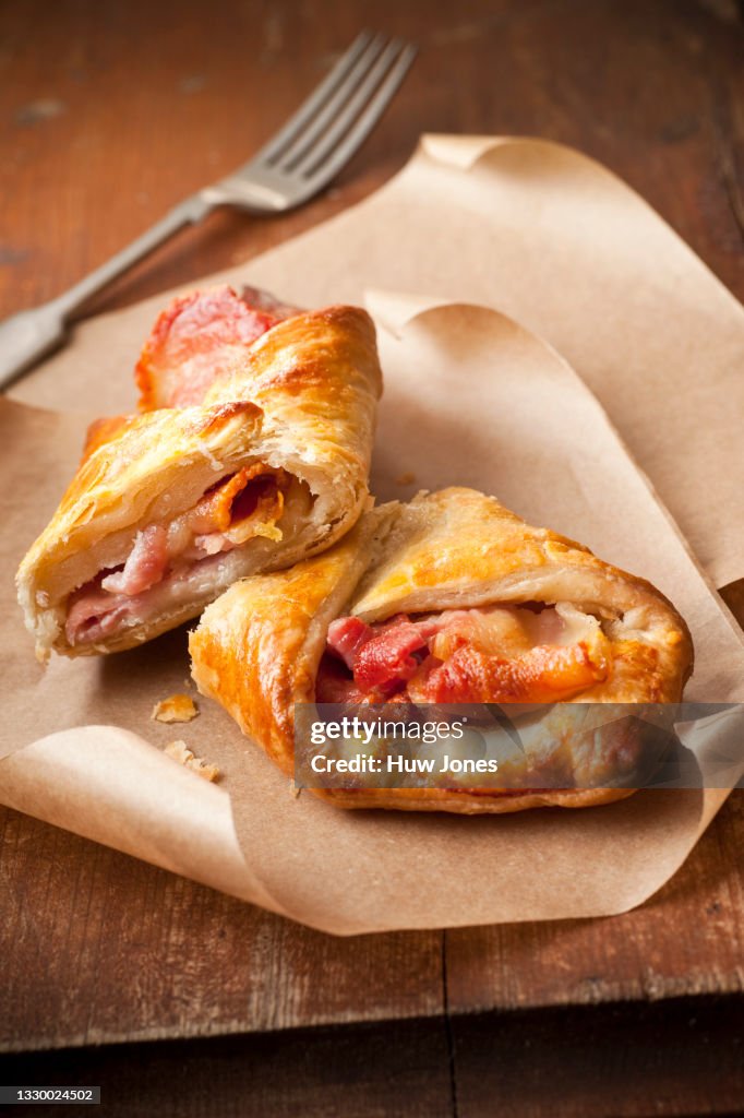 Bacon and cheese puff pastry turnover on parchment paper