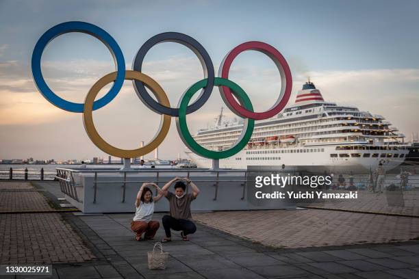 People take pictures in front of Olympics rings on July 22, 2021 in Yokohama, Japan. Olympics opening ceremony director, Kentaro Kobayashi, has been...